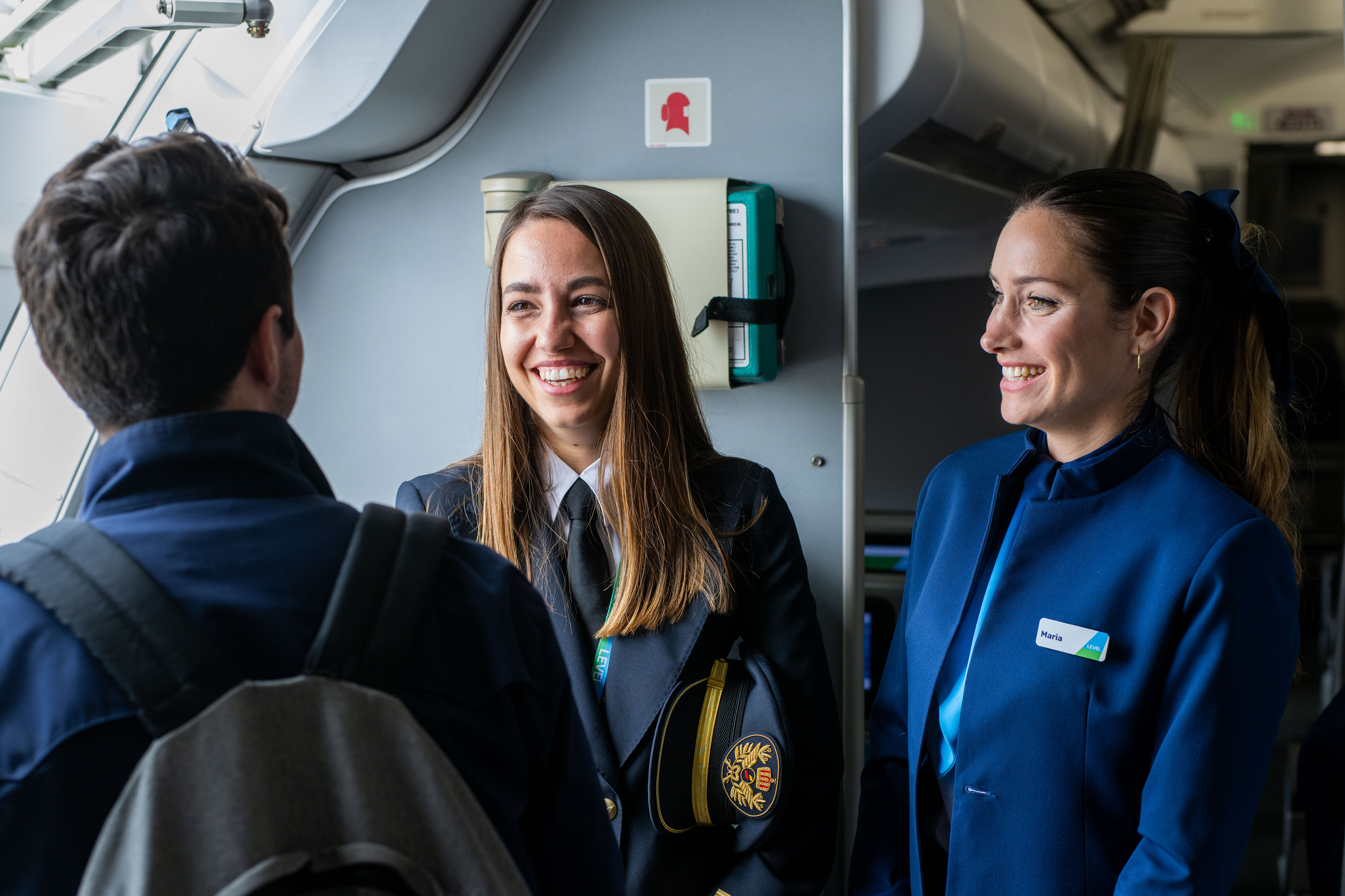 LEVEL cabin crew welcoming passenger on board