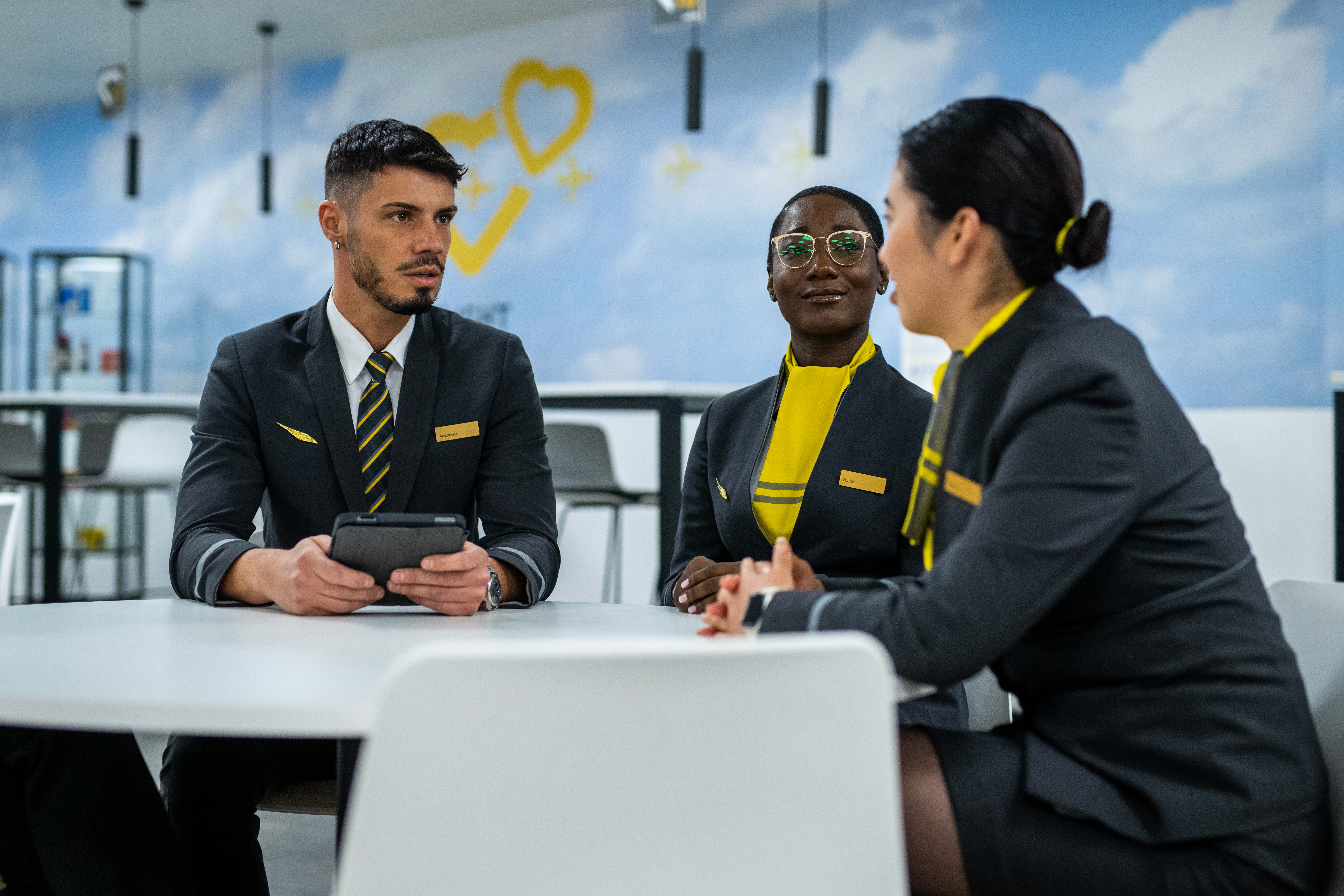 Members of Vueling cabin crew seated round a table