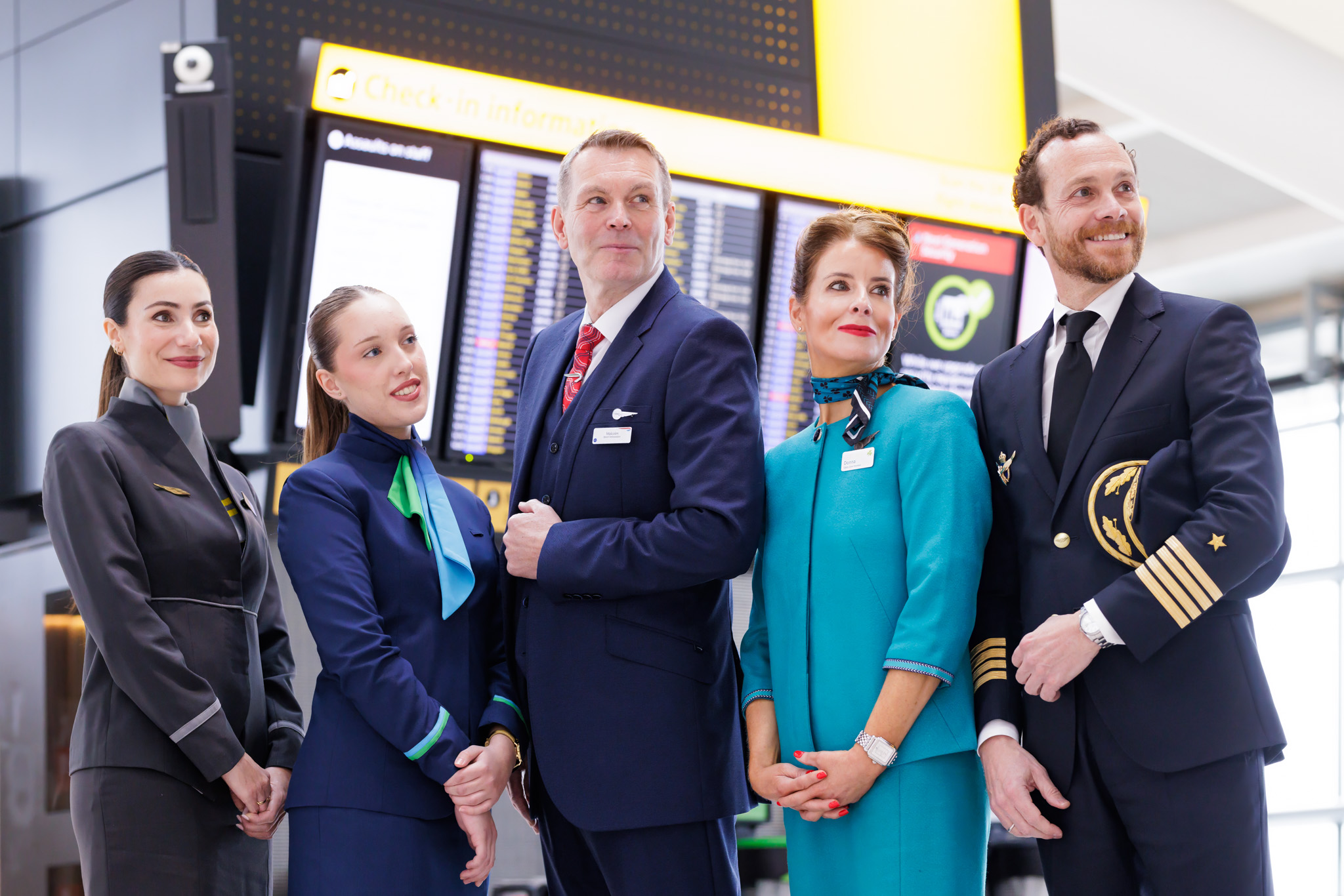 Cabin crew from IAG airlines and Iberia pilot posing at Heathrow