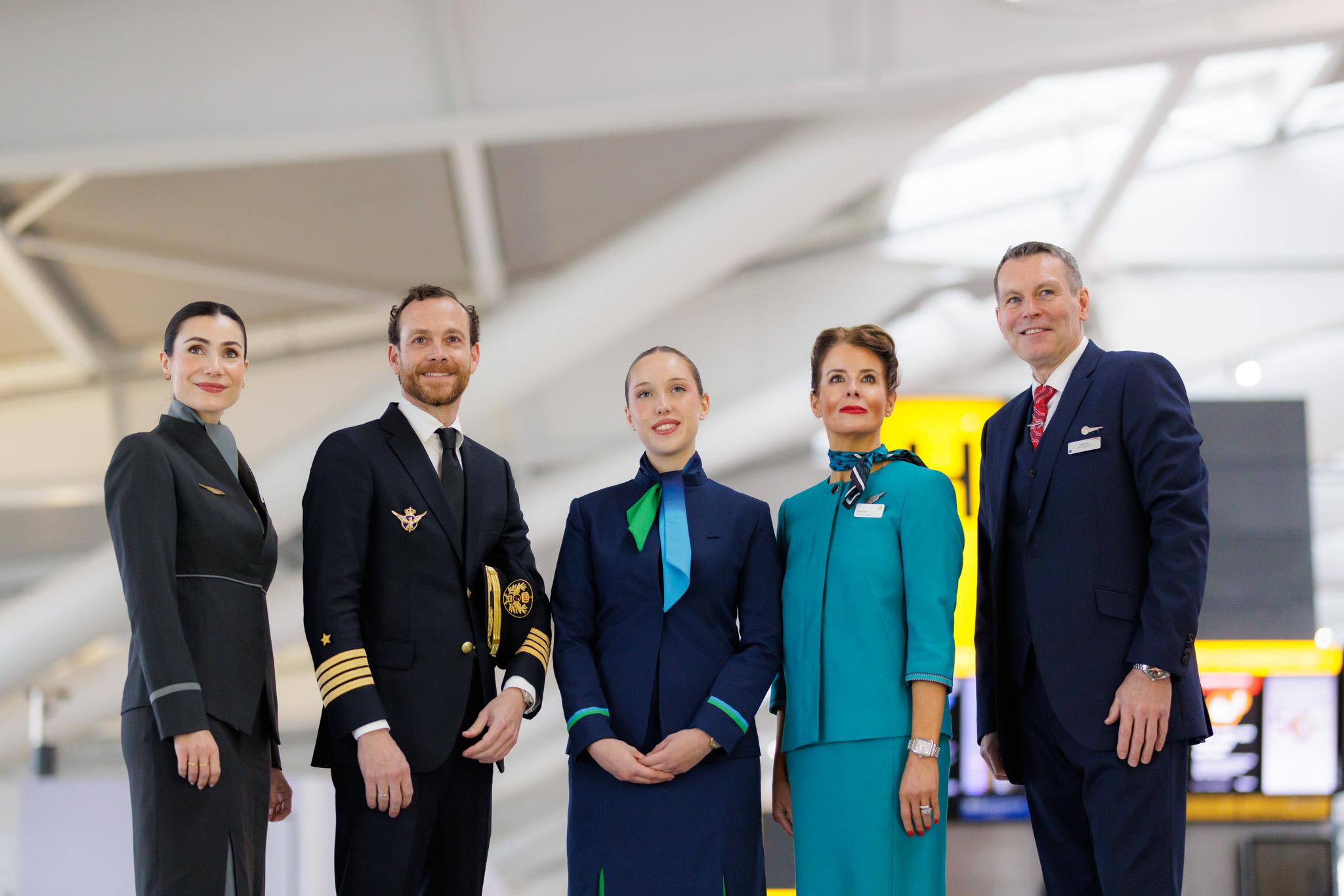 Cabin crew members and Iberia pilot posing at Heathrow T5