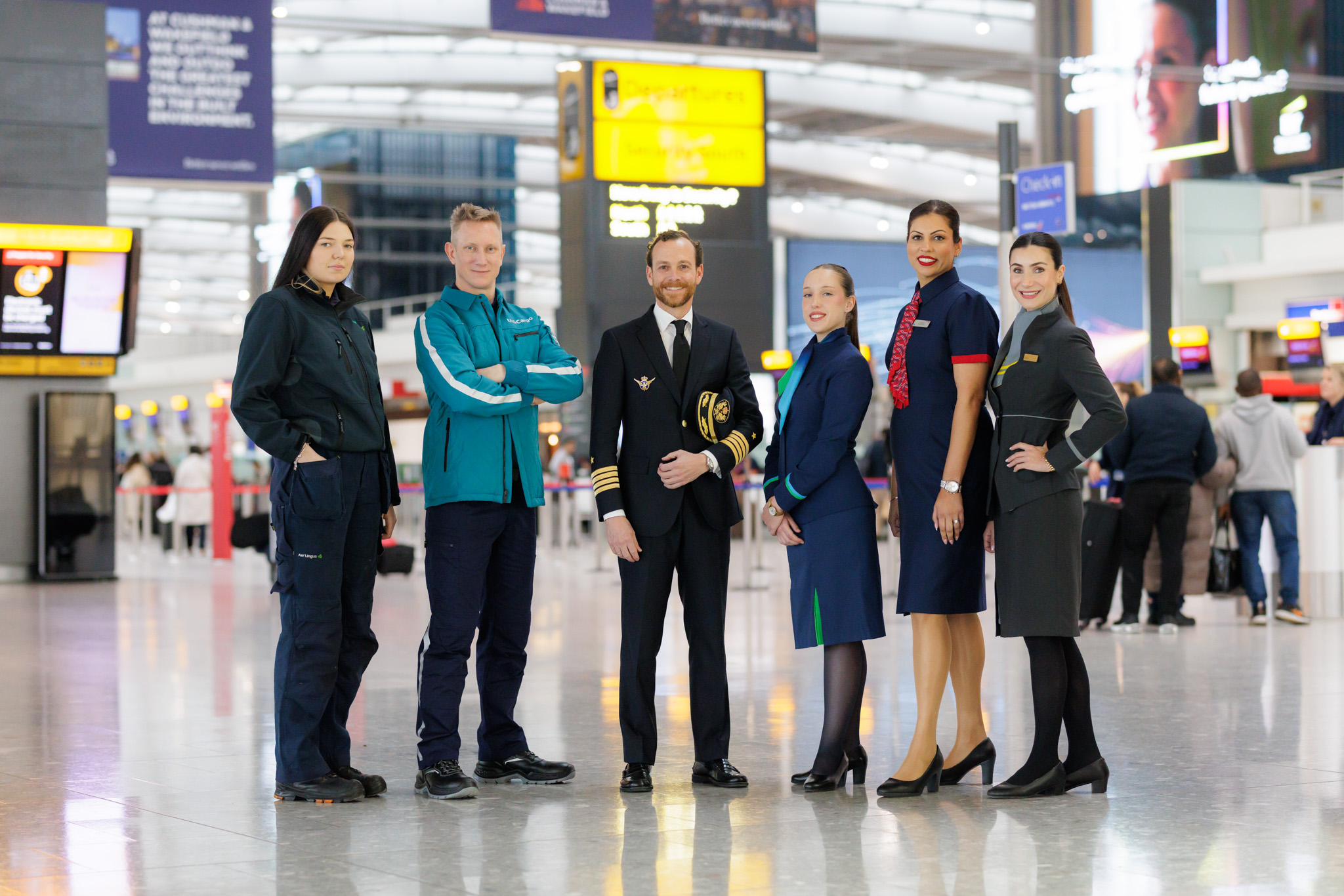 IAG staff posing at Heathrow departures concourse