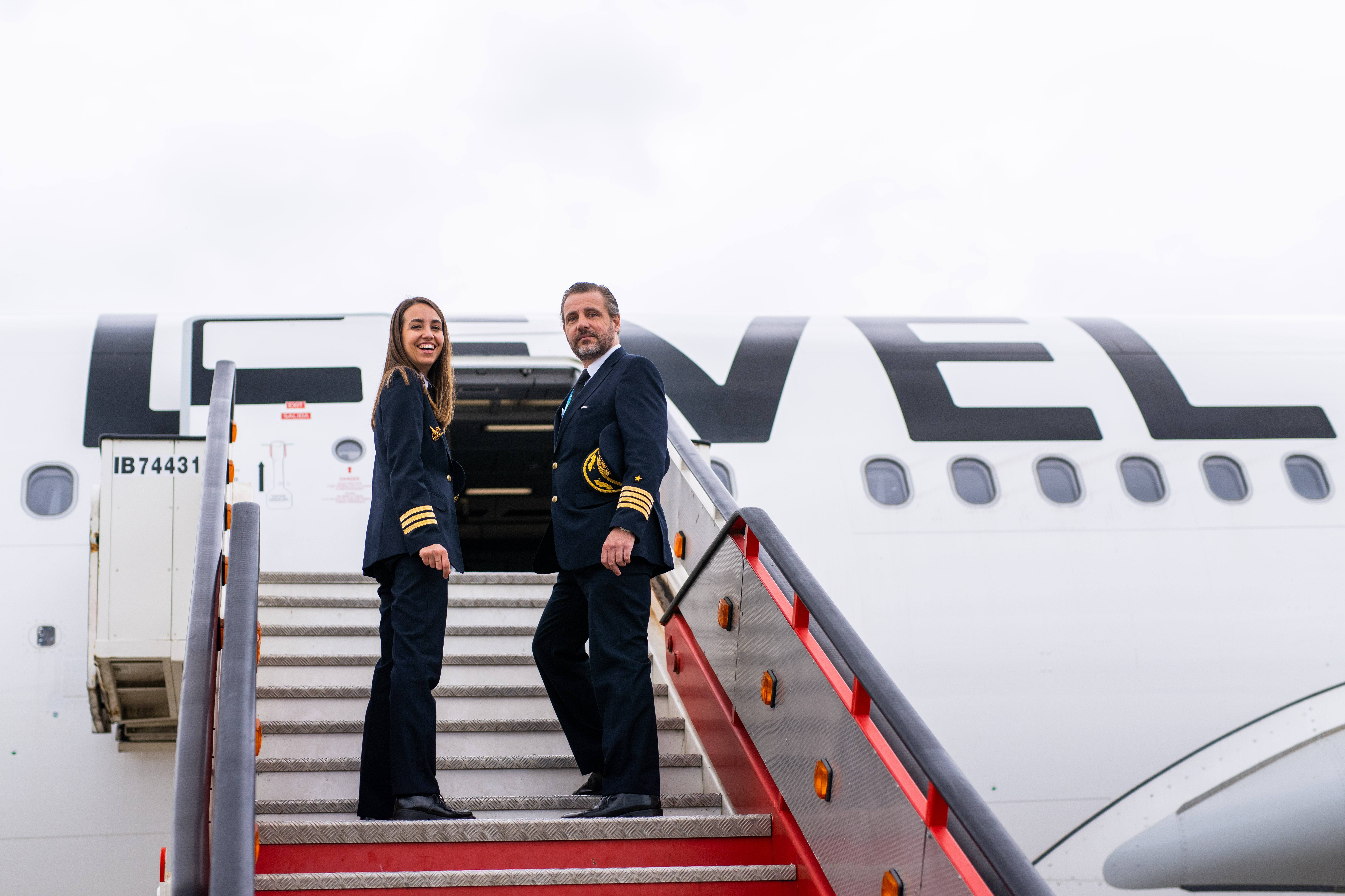 LEVEL cabin crew posing at plane exit