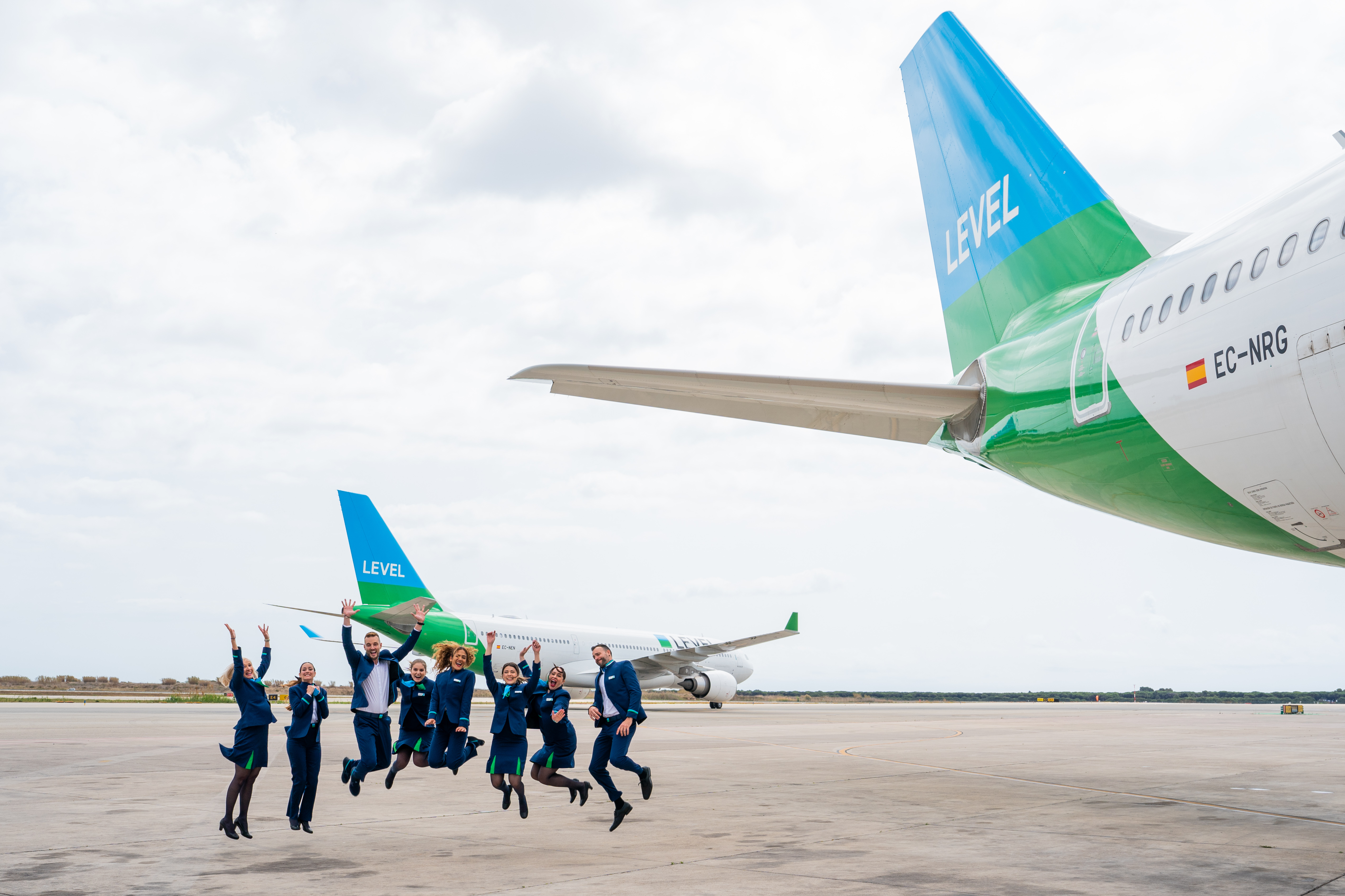 LEVEL cabin crew posing by plane