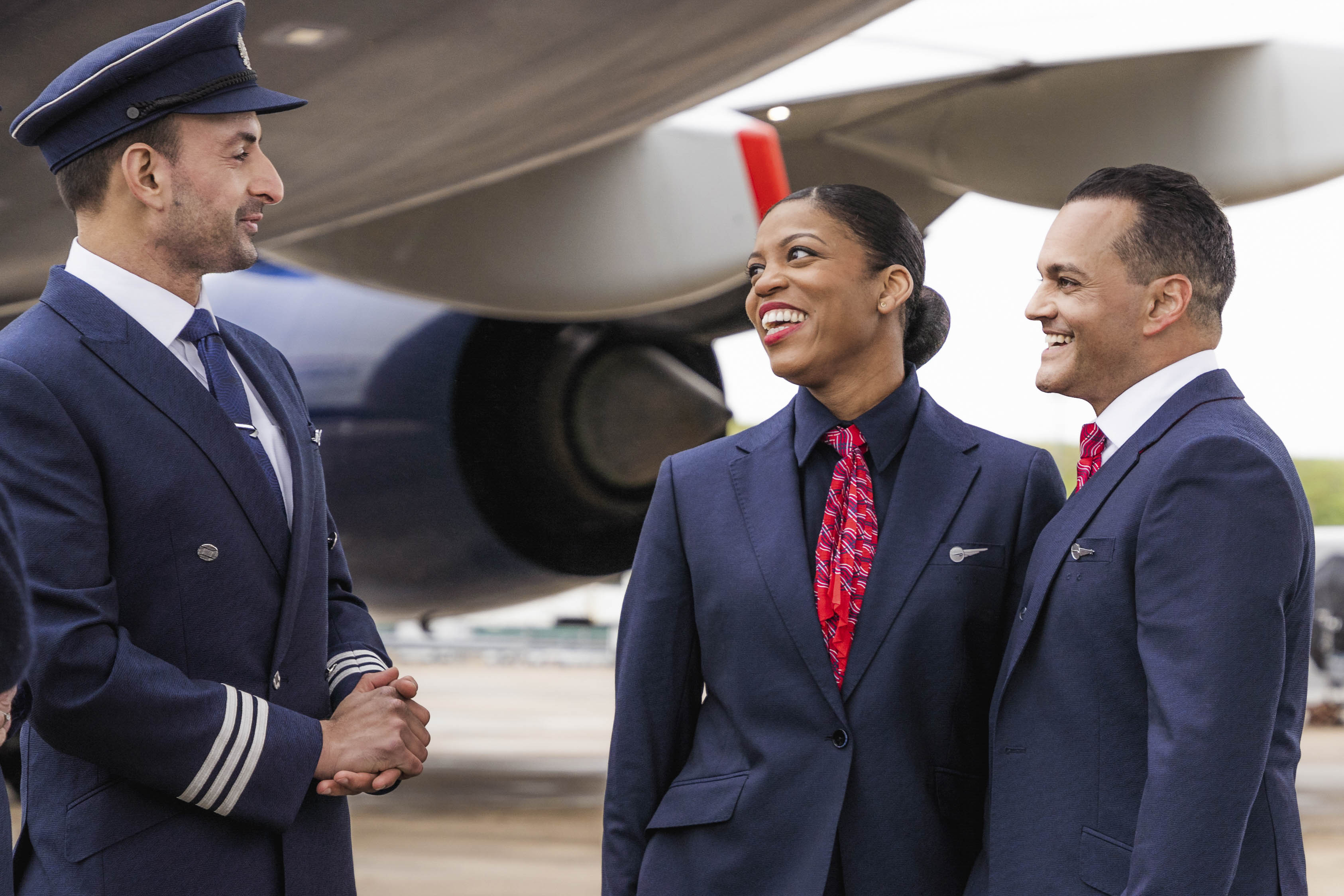 Members of British Airways cabin crew talking to pilot