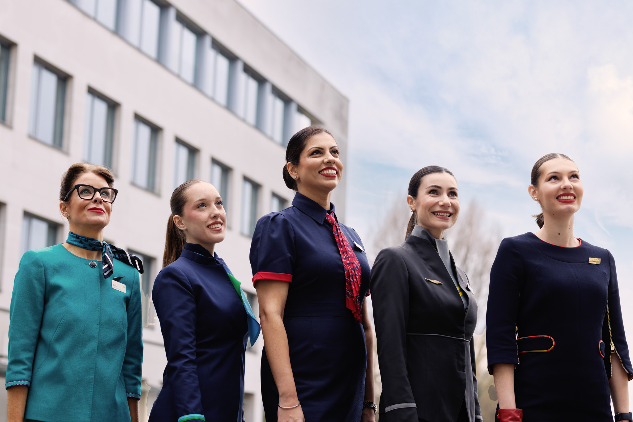 Members of IAG airlines cabin crew posing out headquarters building