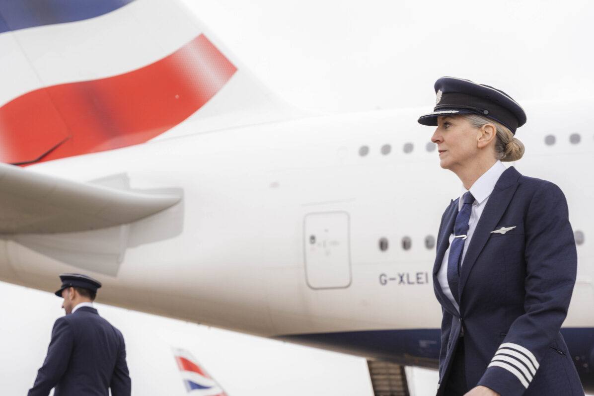 British Airways pilot standing near plane