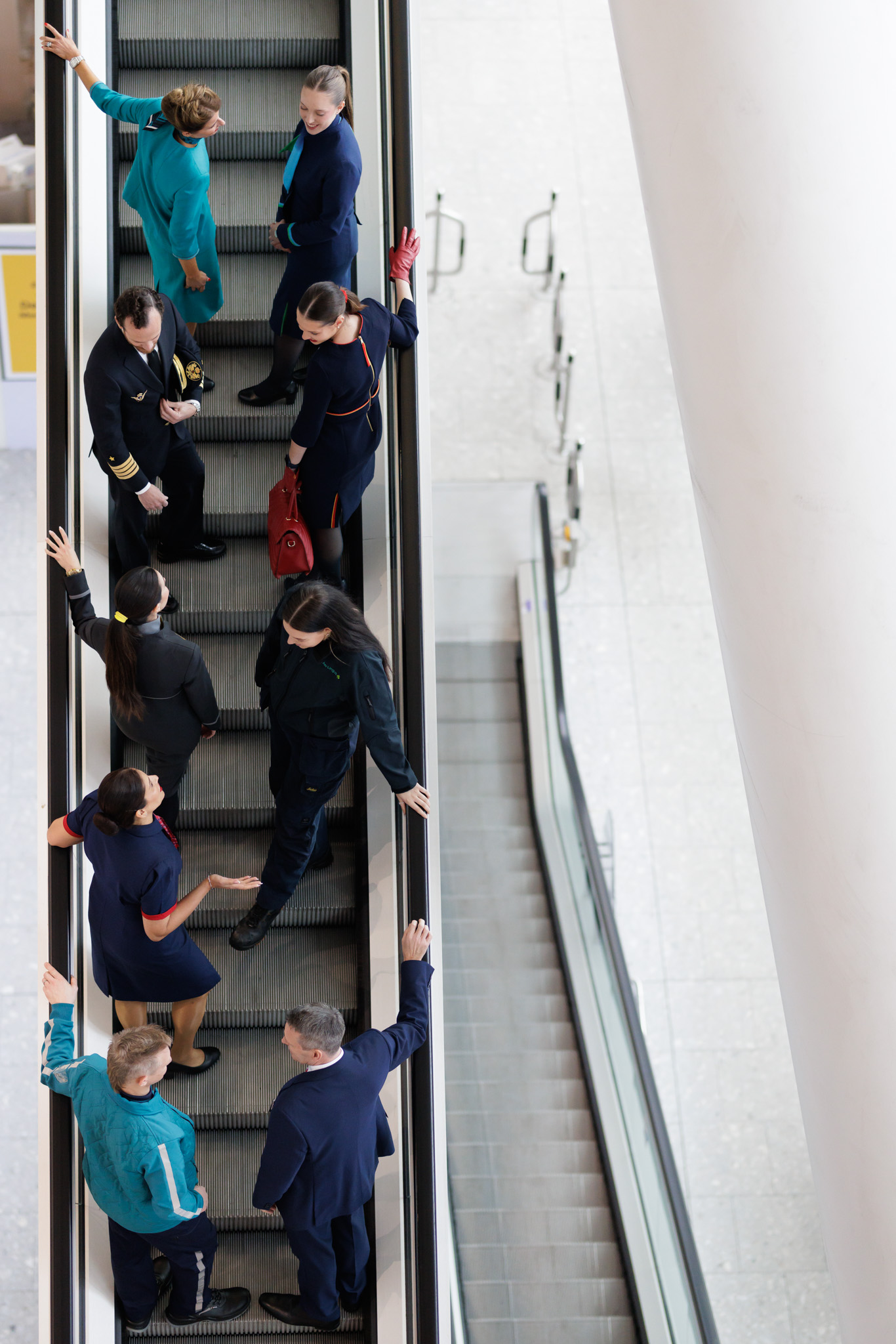 IAG businesses' staff members on escalator at Heathrow